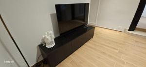 a black entertainment center with a flat screen tv at Plebiscito Apartment in Barletta