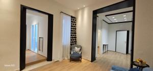 a living room with two large mirrors and a chair at Plebiscito Apartment in Barletta