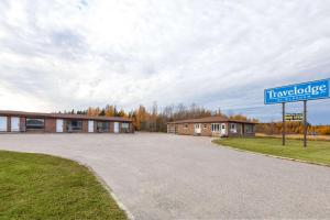 a building with a street sign in front of it at Travelodge by Wyndham Cochrane Ontario in Cochrane