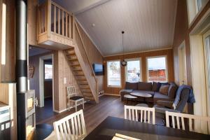 a living room with a couch and a staircase at Perfect Base For Skiing And Local Events in Beitostøl