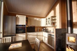 a kitchen with white cabinets and a stove at Perfect Base For Skiing And Local Events in Beitostøl