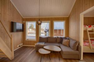 a living room with a couch and a bed at Perfect Base For Skiing And Local Events in Beitostøl +21 photos