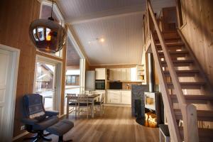 a living room and kitchen with a staircase in a house at Perfect Base For Skiing And Local Events in Beitostøl