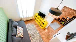 an overhead view of a living room with a couch and a television at Architectural Gem with Modern Flair - Double Studio Old Town in Bucharest