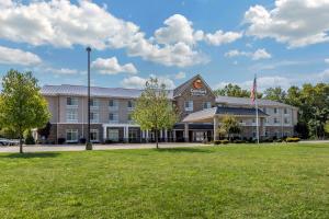 a large building with a flag in front of it at Comfort Inn & Suites Dover in Dover