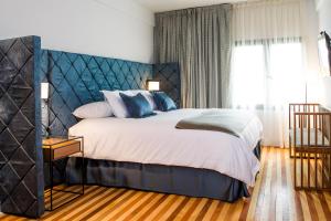 Postel nebo postele na pokoji v ubytování Hotel Luciano K