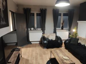 a living room with a couch and a chair at Maison de ville in Bourbourg +14 photos