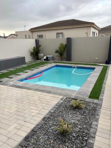 a swimming pool in the backyard of a house at Modern 3 bedroom Urban Getaway in Cape Town