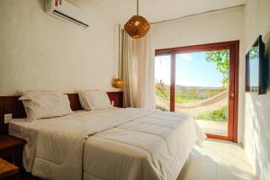 Un dormitorio con una cama grande con una ventana grande. en Santa Maria Inn, en São Miguel do Gostoso 46 fotos más