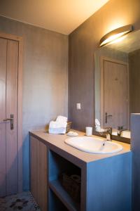 a bathroom with a sink and a mirror at Prokymaia Penthouse Apartment in Rethymno +22 photos