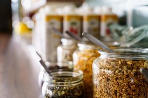 a group of jars filled with nuts on a counter at The Nooq Alvik - Hotel & Studios in Stockholm +29 photos