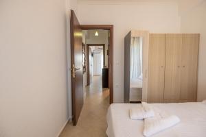 a bedroom with a bed with two towels on it at Tranquil Getaway by InFox Suites in Afitos +41 photos