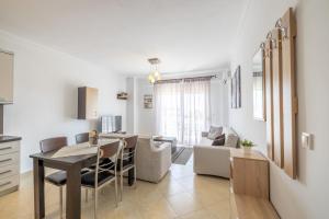 a kitchen and living room with a table and chairs at Tranquil Getaway by InFox Suites in Afitos