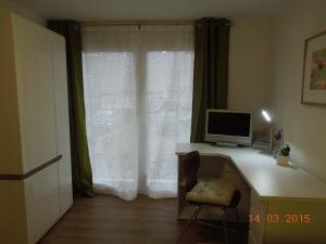 a computer sitting on a desk in front of a window at Ferienwohnung Merzenbühl in Bad Überkingen