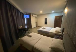 Voodi või voodid majutusasutuse Hotel Harbour Inn toas