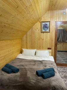 a bed in a wooden room with two pillows on it at SkyView in Artabuynkʼ