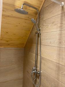 a shower in a bathroom with a wooden wall at SkyView in Artabuynkʼ +13 photos