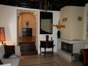 a living room with a couch and a fireplace at Christina's Villa with sea view in Daratso