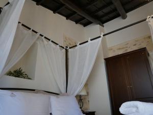 a bedroom with a canopy bed with white curtains at Christina's Villa with sea view in Daratso +58 photos