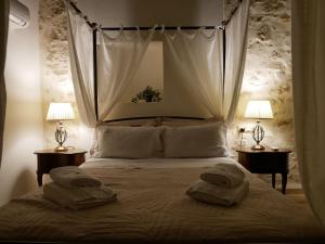 a bedroom with a bed with two towels on it at Christina's Villa with sea view in Daratso