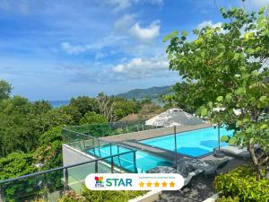 a view of a swimming pool from a house at Clarian Hotel Beach Patong in Patong Beach +174 photos