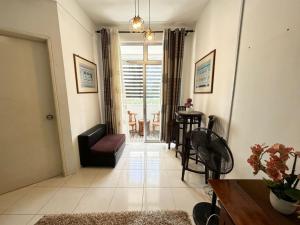a living room with a couch and a table at Residence Homestay Wakaf Che Yeh in Kota Bharu