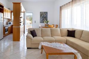 a living room with a couch and a table at Iconic Villa with private pool and sea view in Próvarma +29 photos