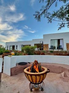 a fire pit in a yard in front of a building at Escape Pretoria East Luxury Villa in Tierpoort