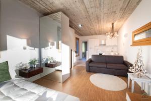 a living room with a couch and a kitchen at Green forest - Ixihome in Cadegliano Viconago +33 photos