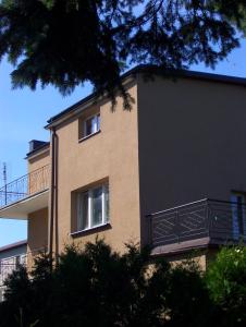 a large building with two windows and a balcony at Noclegi Słodki Sen 1 in Lublin