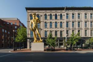 a large statue of a man on top of a city street at 21c Museum Hotel Louisville in Louisville