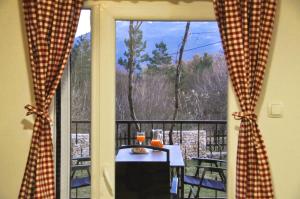 a room with a table and a window with a view at Kuća za odmor Bela Goranci in Mostar