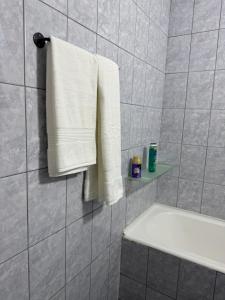 a bathroom with a white towel hanging on a wall at National Stadium Aparment in Bucharest