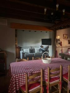 a table with a basket on top of it with a couch at As Tres Irmas in Candeleda