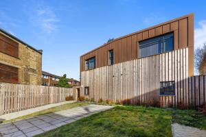 a house with a wooden fence in front of it at Sercasa - Kingston upon Thames in Kingston upon Thames