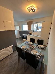 a kitchen and dining room with a table and chairs at Apartment Oberleins I in Arzl im Pitztal