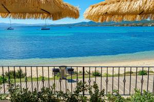 a view of the beach from the balcony of a resort at Appartamento Vista Marina direttamente sulla spiaggia con vista mare in Golfo Aranci +26 photos