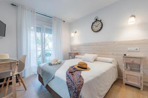 a bedroom with a bed and a clock on the wall at El Nogal Home in Málaga