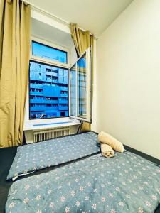 a bedroom with a bed in front of a window at 3BR Shared Apartment, in the Heart of Vienna in Vienna +23 photos