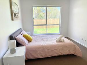 a bedroom with a bed and a large window at Brand New Home - Spacious Family Retreat in Park Ridge