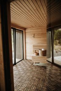 a room with a sauna with a bench and windows at Forestic Lietuva in Vilionys
