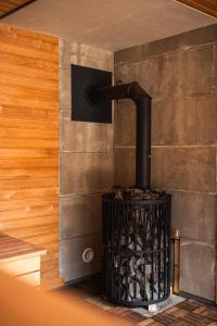 a woodburning stove in the corner of a room at Forestic Lietuva in Vilionys