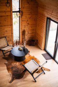 a room with a table and chairs in a log cabin at Forestic Lietuva in Vilionys