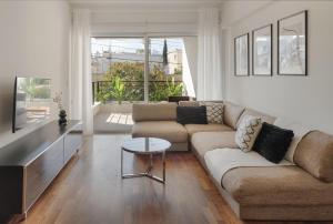 a living room with a couch and a table at Phaedrus Living Evergreen Nicosia City Residence in Nicosia