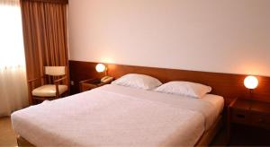 Cama ou camas em um quarto em Hotel Santo Andre