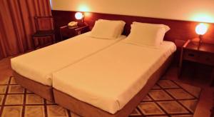 Cama ou camas em um quarto em Hotel Santo Andre