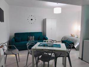 a living room with a couch and a table and chairs at NAHAR HOME in Naro