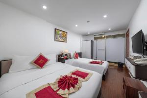 Postel nebo postele na pokoji v ubytování Hanoi Aria Central Hotel & Spa