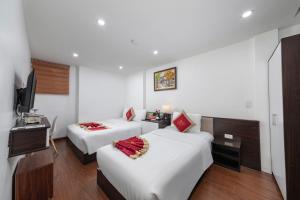 Postel nebo postele na pokoji v ubytování Hanoi Aria Central Hotel & Spa