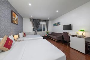Postel nebo postele na pokoji v ubytování Hanoi Aria Central Hotel & Spa + 37 fotografií
